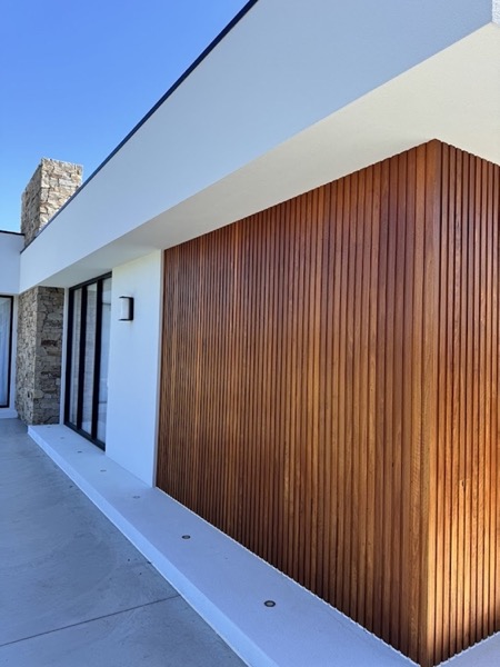 A vertical timber batten wall on the outside of a house